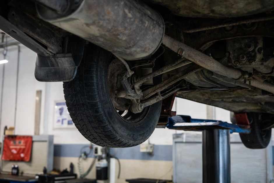 Professional mechanic examining a car tire during installation